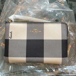 Navy blue and white checked coach wristlet. Brand new never used.